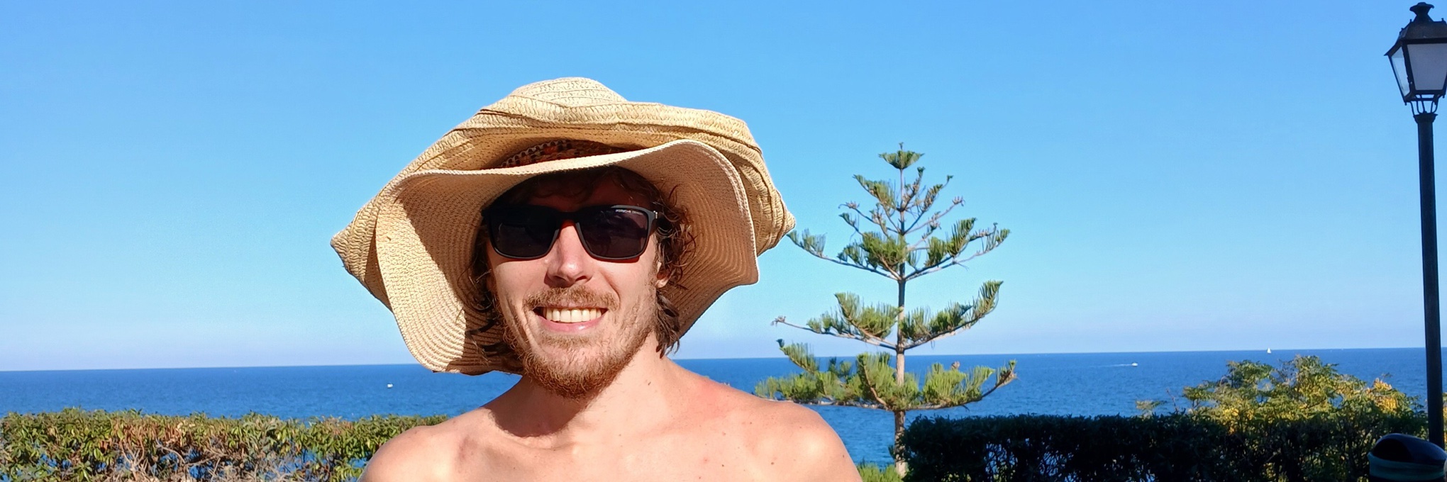 Dima mit Strohhut, entspannt an einem sonnigen Tag